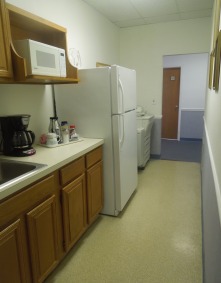 Accommodating kitchen with sink, refrigerator, coffeemaker and microwave